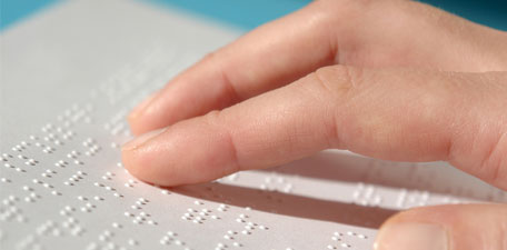 Image of person reading braille